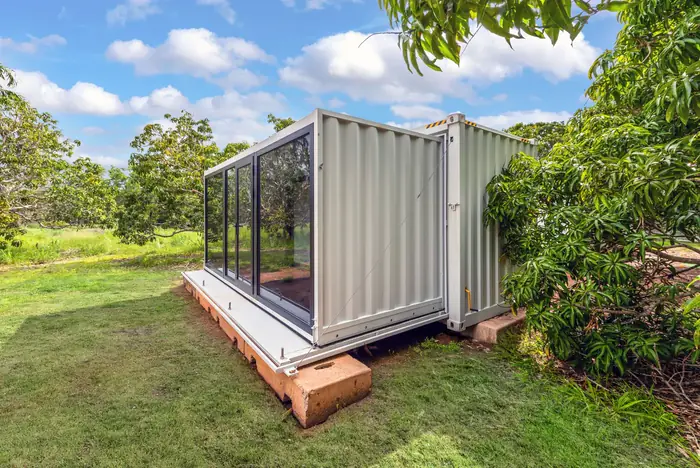 The Infinity Cube expanded on site with its glass frontage open to the garden